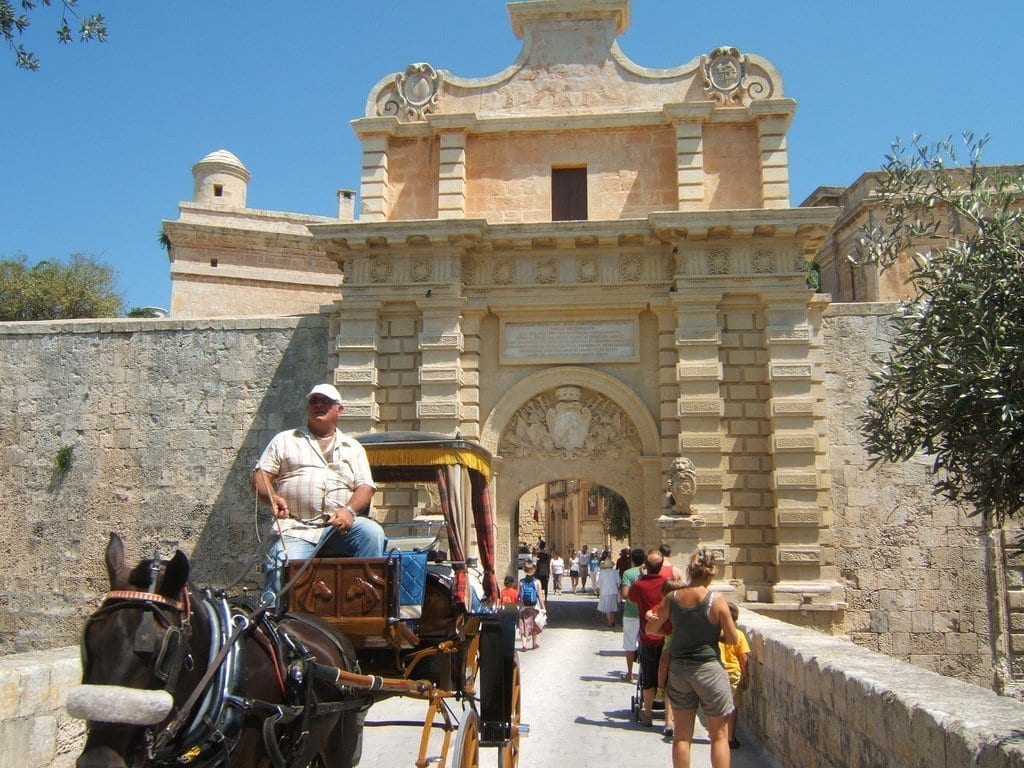 Mdina city gate picture and horse carriages in beautiful malta