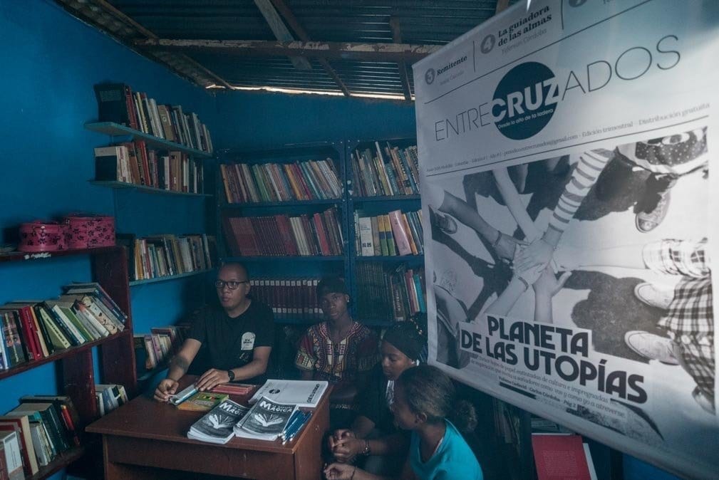 life in colombia - students of suenos de papel showing their articles and newspaper