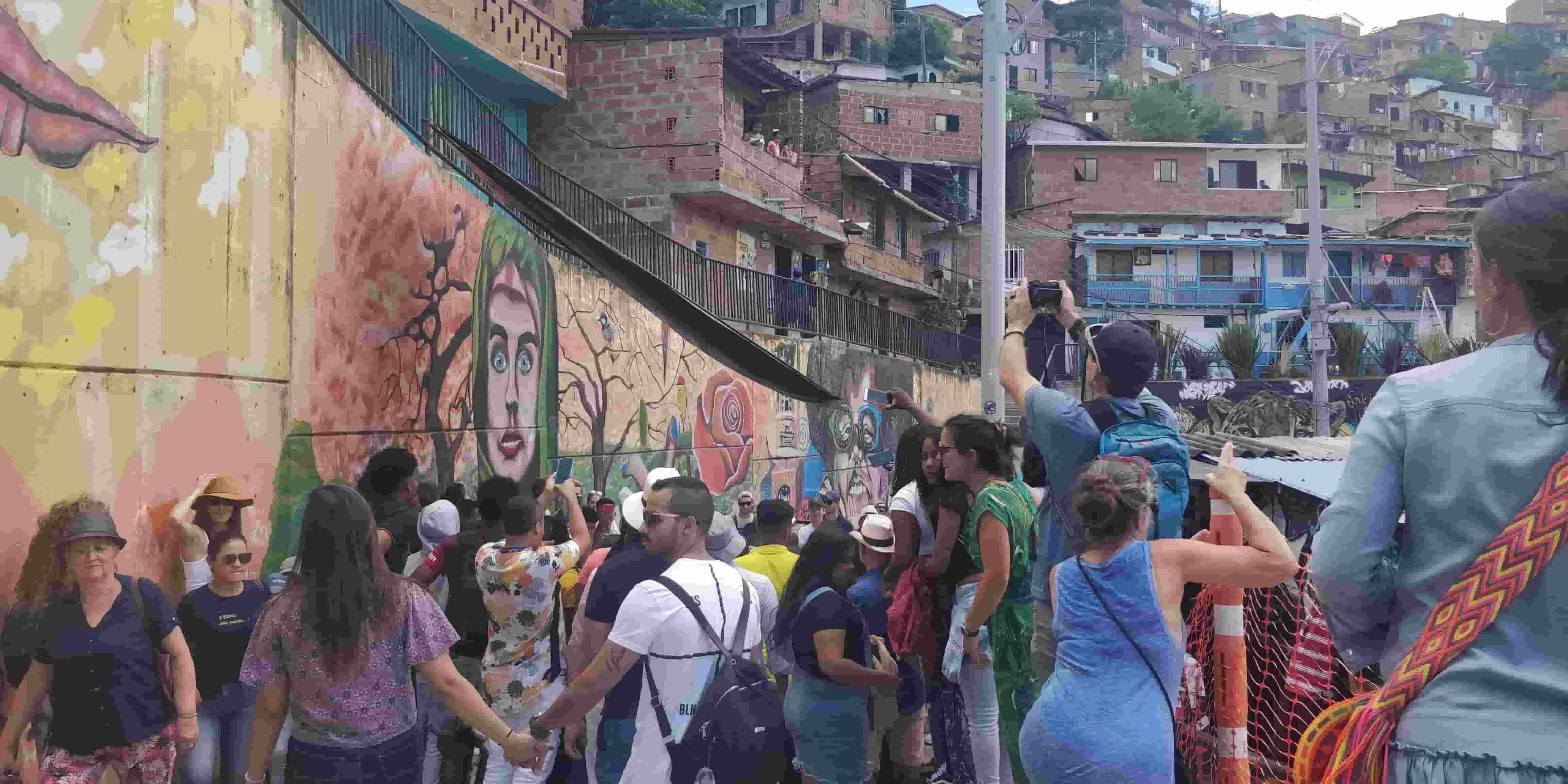 comuna13 crowds in the barrio to check out the graffiti